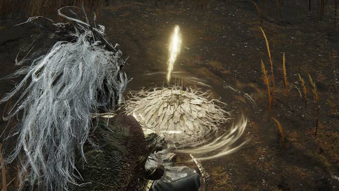 A warrior sits at a Site of Grace in Shadow of the Erdtree.