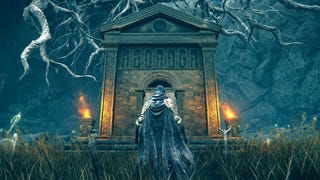 The player in Elden Ring stands with their back to the camera in front of the entrance to a Mausoleum dungeon in the Shadow Of The Erdtree DLC.