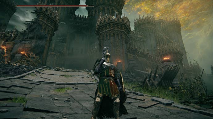 Elden Ring player standing on steps as a large castle looms in the background