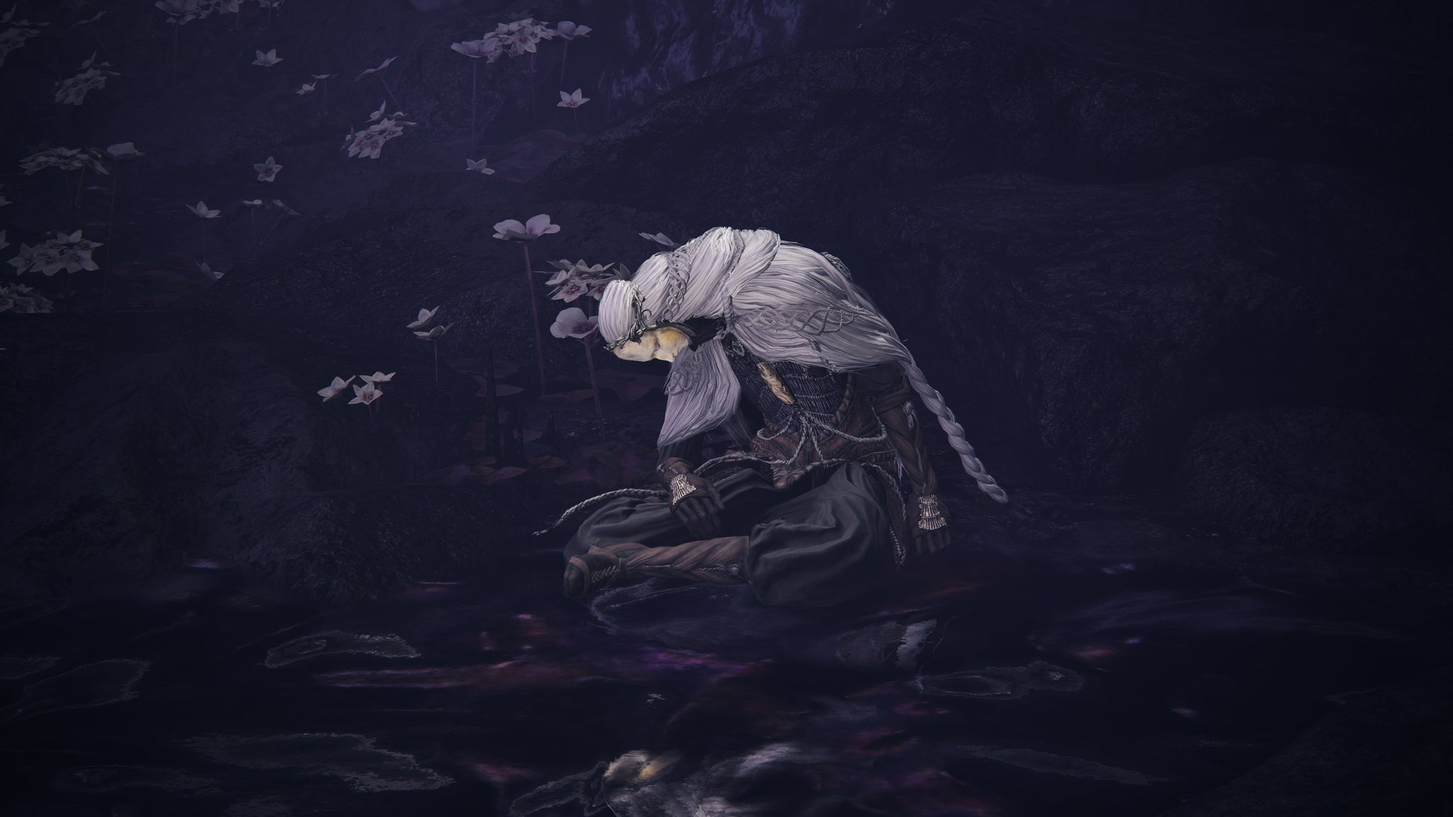 A close-up of Thiollier in Elden Ring: Shadow Of The Erdtree, slumped in a pool of purple nectar. - 13