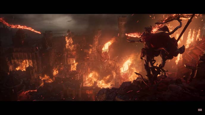 Messmer The Impaler stands above a burning city in Elden Ring Shadow Of The Erdtree