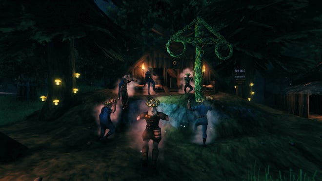 A handful of Valheim characters dancing around a maypole at night time. They seem to be having fun.