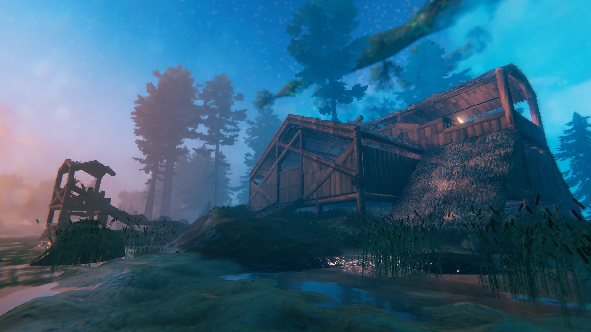 An elaborate log cabin in Valheim, with a grand, jutting balcony. It&rsquo;s captured in dreamy peachy and turquoise colours at sunset. Someone is quite the photographer, Emma.