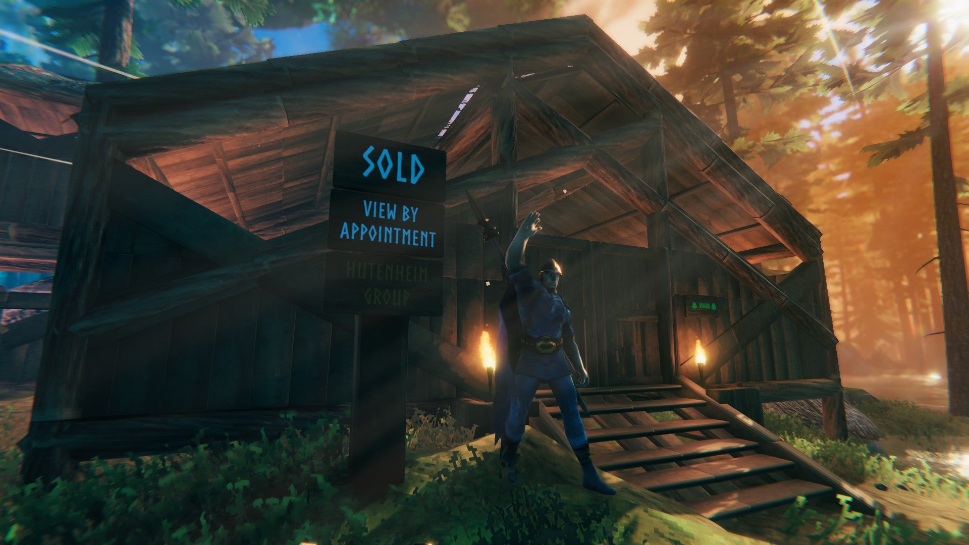 A Valheim player cheers, standing in front of a wooden cabin they have clearly just bought - as evidenced by the &ldquo;sold&rdquo; sign right next to them.