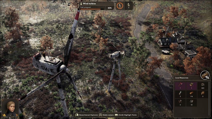 A human walks atop a ruined wind turbine, looking over the dim landscape.