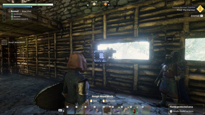 The player in Enshrouded creates a window in a house wall, one block at a time.