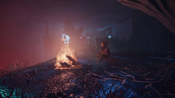 A player in Enshrouded sits beside a campfire at night.