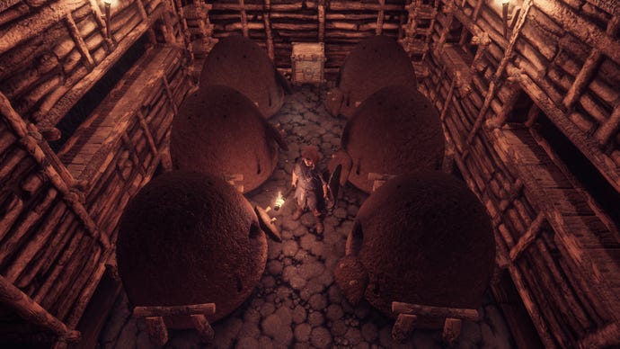 The player in Enshrouded stands amid six Charcoal Kilns in a dimly lit room.