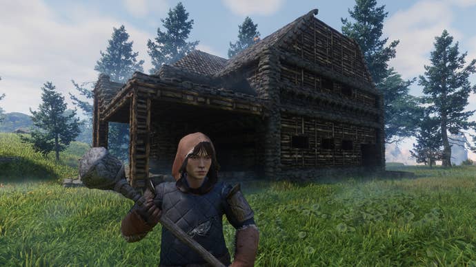 The player in Enshrouded stands outside their home, wielding a pickaxe.