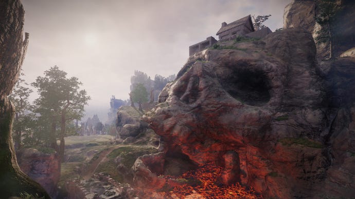 A skull carved into the landscape in Enshrouded.