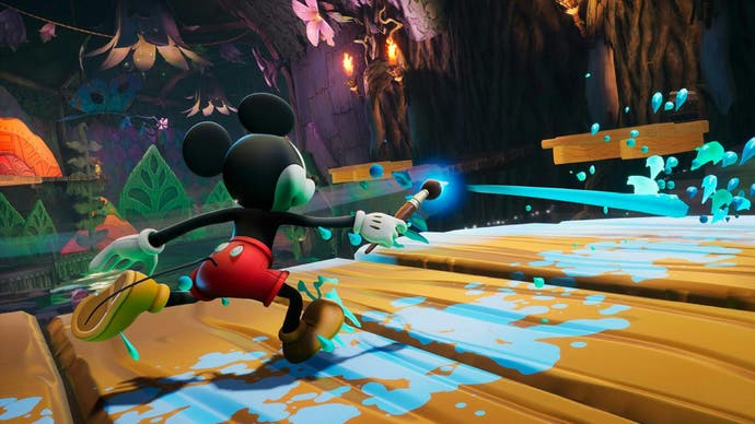 A Disney Epic Mickey: Rebrushed screenshot showing Mickey running along a wooden walkway in a dark fantasy kingdom while splashing paint around with his Magic Paintbrush.