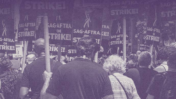 Purple faded image of people striking holding up SAG-AFTRA signs