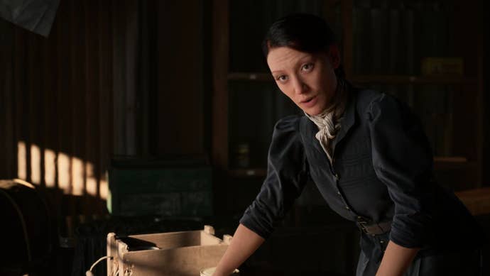 A person of Hanna's argues with her portion penning thing astatine a desk.