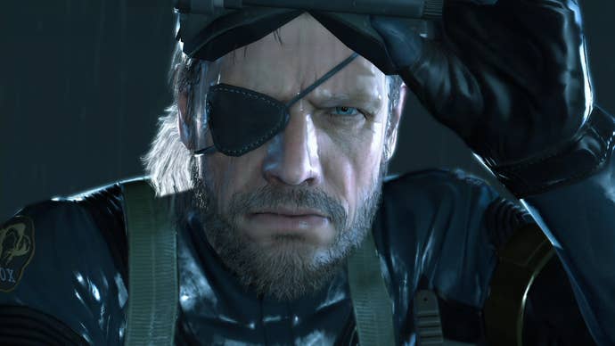 A close-up of the eye-patch-wearing protagonist of Metal Gear Solid: Ground Zeroes, with a grizzled beard and body armour.