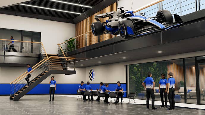 An F1 facility with a hanging F1 display car in F1 25’s MyTeam 2.0 mode.