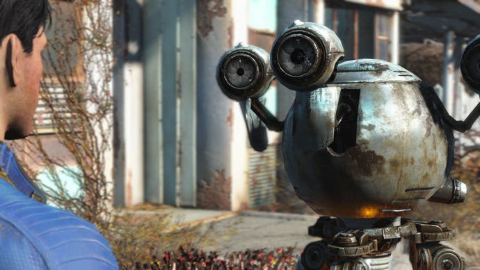 A man in a blue jumpsuit talks to a robot in Fallout 4