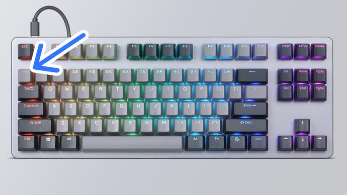 Arrow pointing at backtick key on keyboard.
