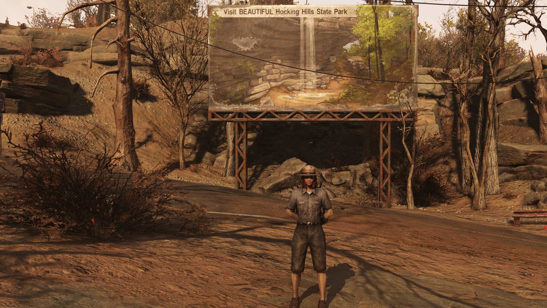 Our friendly tour guide stands in front of Hocking Hills sign