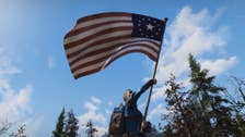 A Fallout 76 player waving the Fallout version of the US flag.