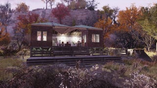 A exterior shot of Emma's fashion boutique in Fallout 76. It's a small building with an open middle, and you can see mannequins modelling clothes in the windows on the outside of the building. It's nice.