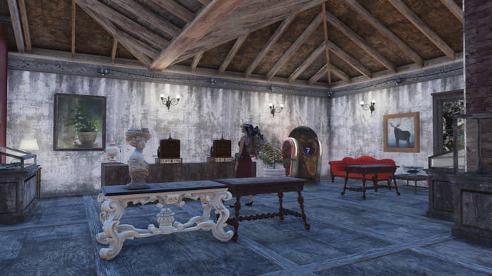 An interior shot of Emma’s lovely fashion boutique in Fallout 76. It’s an open-planned central area with a wooden steepled roof, and some plush furniture. It’s all very organised and spacey, with a few display cabinets around.