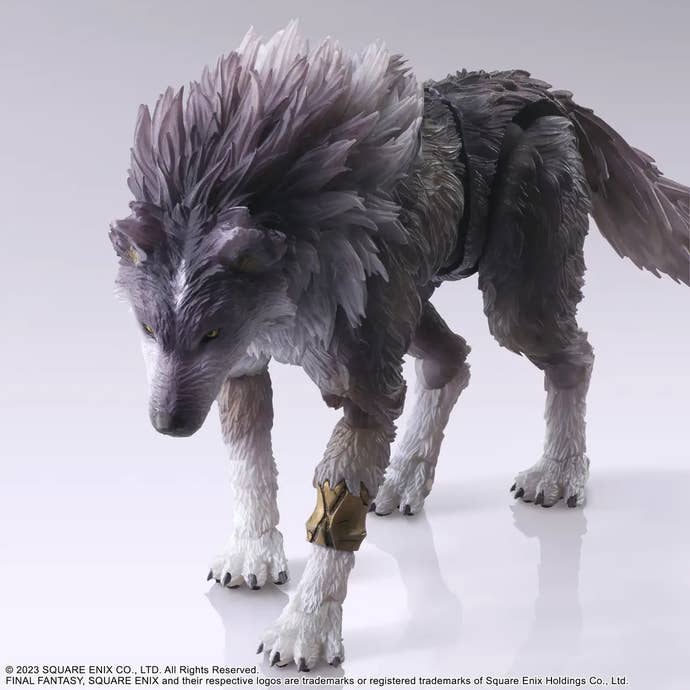 A Play Arts Kai figure of Torgal the wolf from Final Fantasy 16, standing in a feral stance with an aggressive expression on its face, head lowered towards the camera and paws primed for an assault.