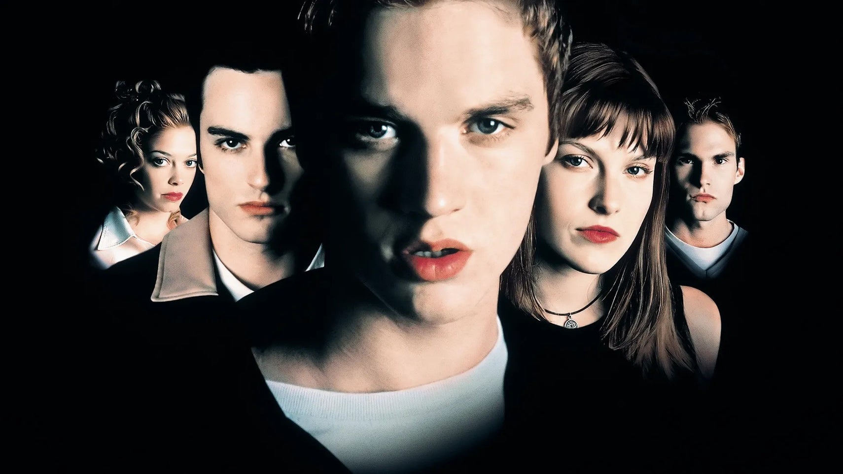 The cast of the original Final Destination all line-up partially covered in shadow. - 1