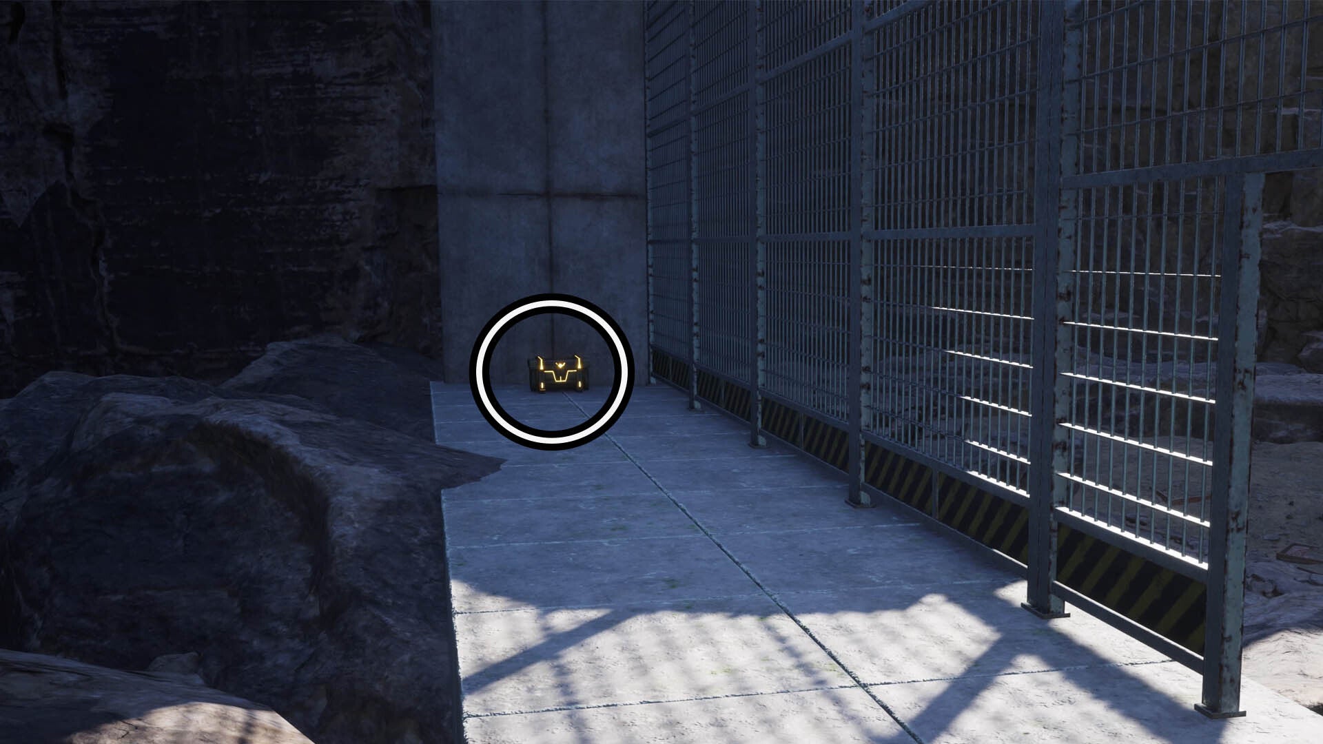 A circle surrounds a reward box at the end of a concrete path next to some metal grates.