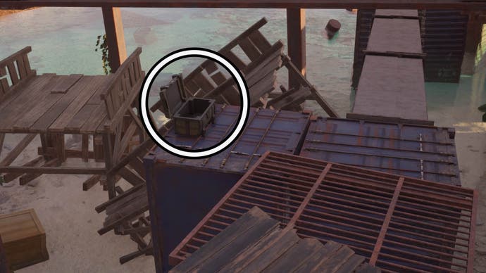 A circle highlights an open rewards chest sitting on top of a blue cargo container.