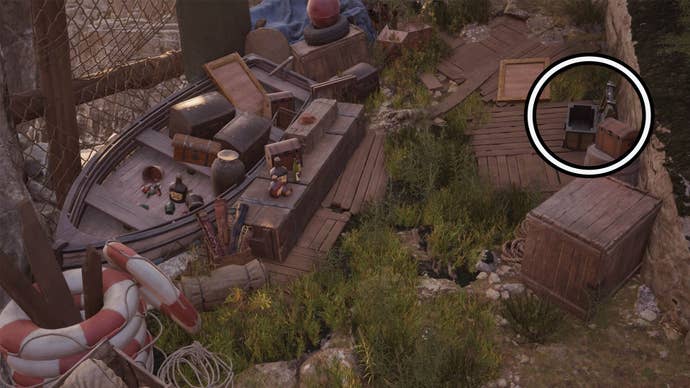 A circle highlights an open reward chest on the right side of the screen, it’s among abandoned treasure and opposite a wooden rowing boat filled with items.