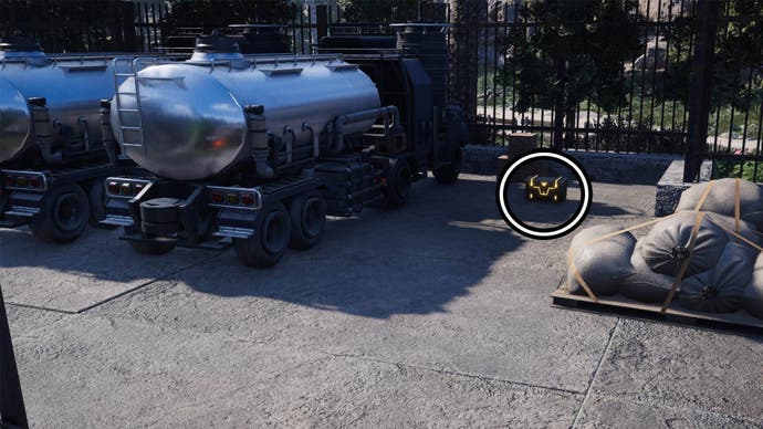 A circle highlights a reward chest that's on the ground beside two fuel tanker trucks.