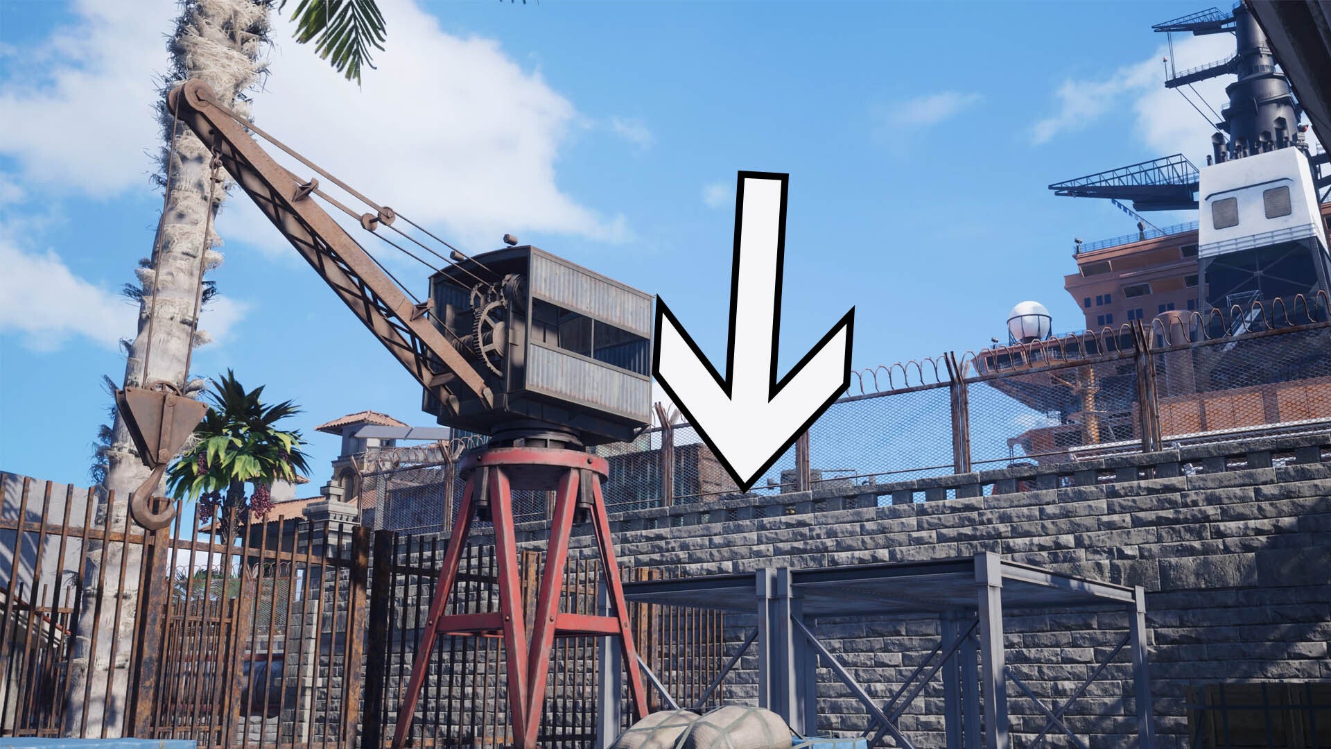 A large arrow is pointing down to the roof of a grey shelter behind a small crane against a stone wall.