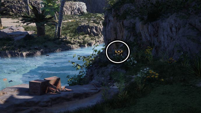 A circle highlights a reward box sitting in the shadows near a cliff.