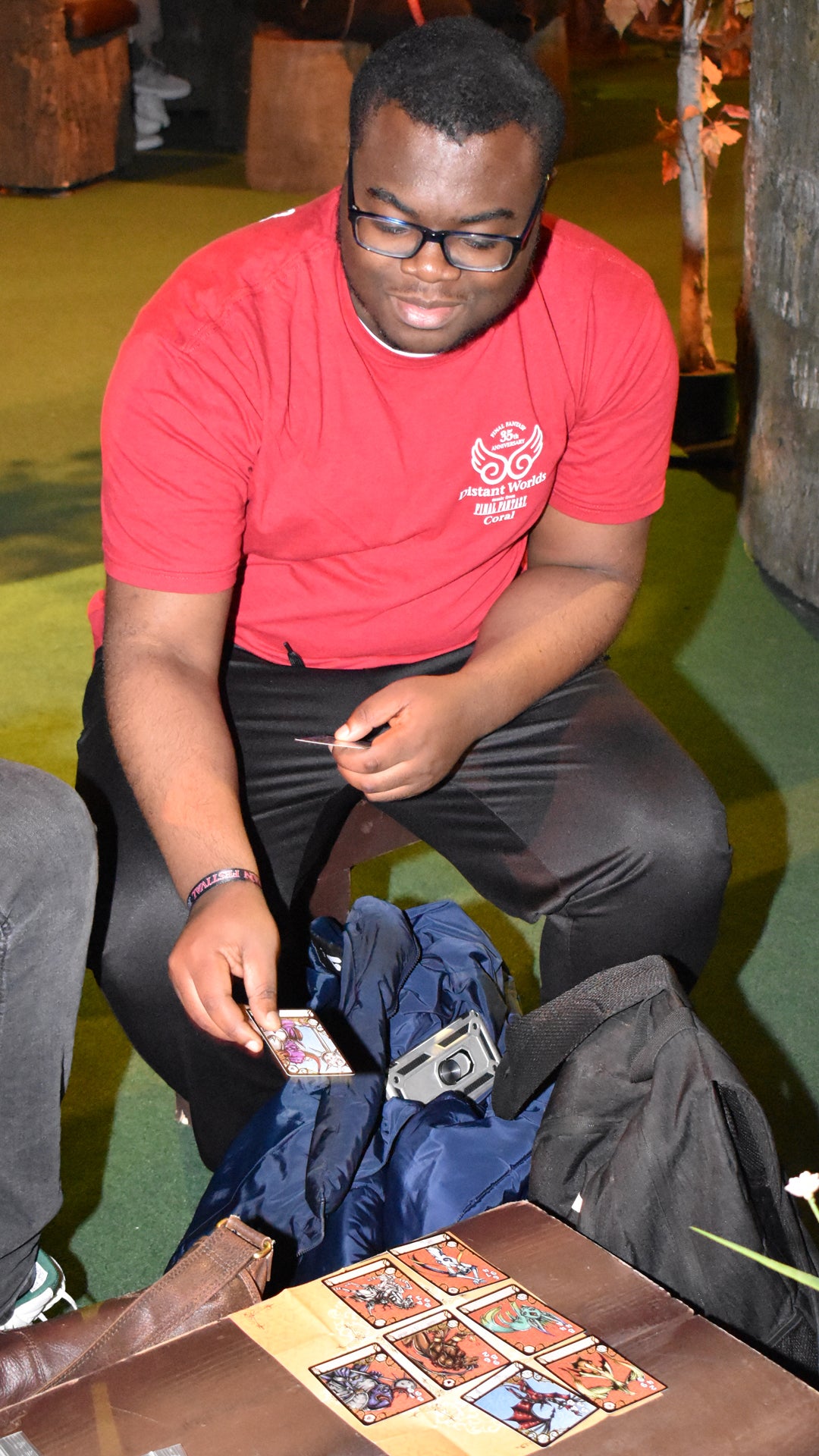 Benjamin placing a card on the Triple Triad grid at Final Fantasy Fan Fest