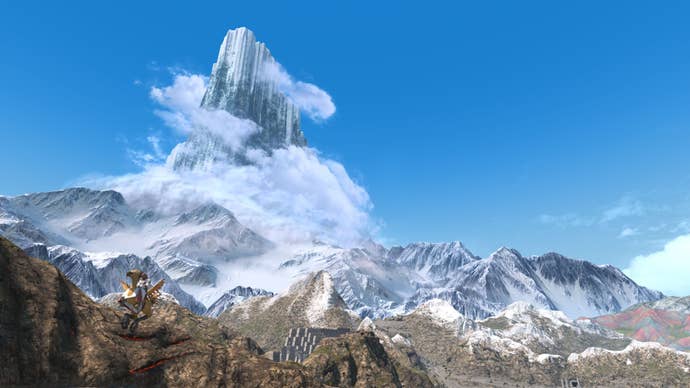 A towering mountain surrounded by clouds.