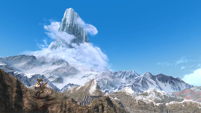 A towering mountain surrounded by clouds.