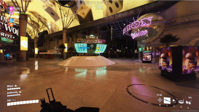 A screenshot of a match in action in The Finals. Bertie stands in the atrium of a huge casino complex. Everything is shiny and lit up and digital. It's gaudy but also quite impressive