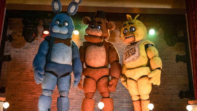 From left to right, a blue rabbit, brown bear, and yellow chick animatronic in the Five Nights at Freddy’s movie.