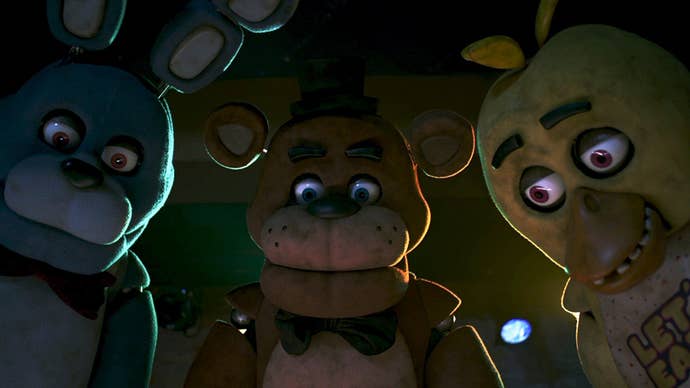 Bonnie, Freddie, and Chica all crowded round something offscreen in the Five Nights at Freddy’s movie.