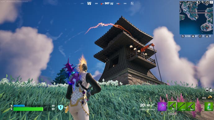 Fortnite, a character is facing the Lighthouse at the top of the hill.