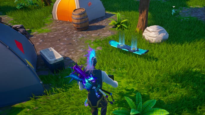 fortnite og character looking at hoverboard outside tents near loot lake