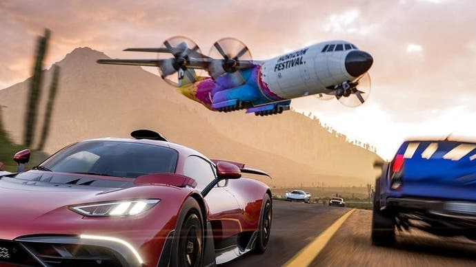 A red supercar driving down a road with a blue pickup truck going in the other direction and a plane with propellors flying overhead.