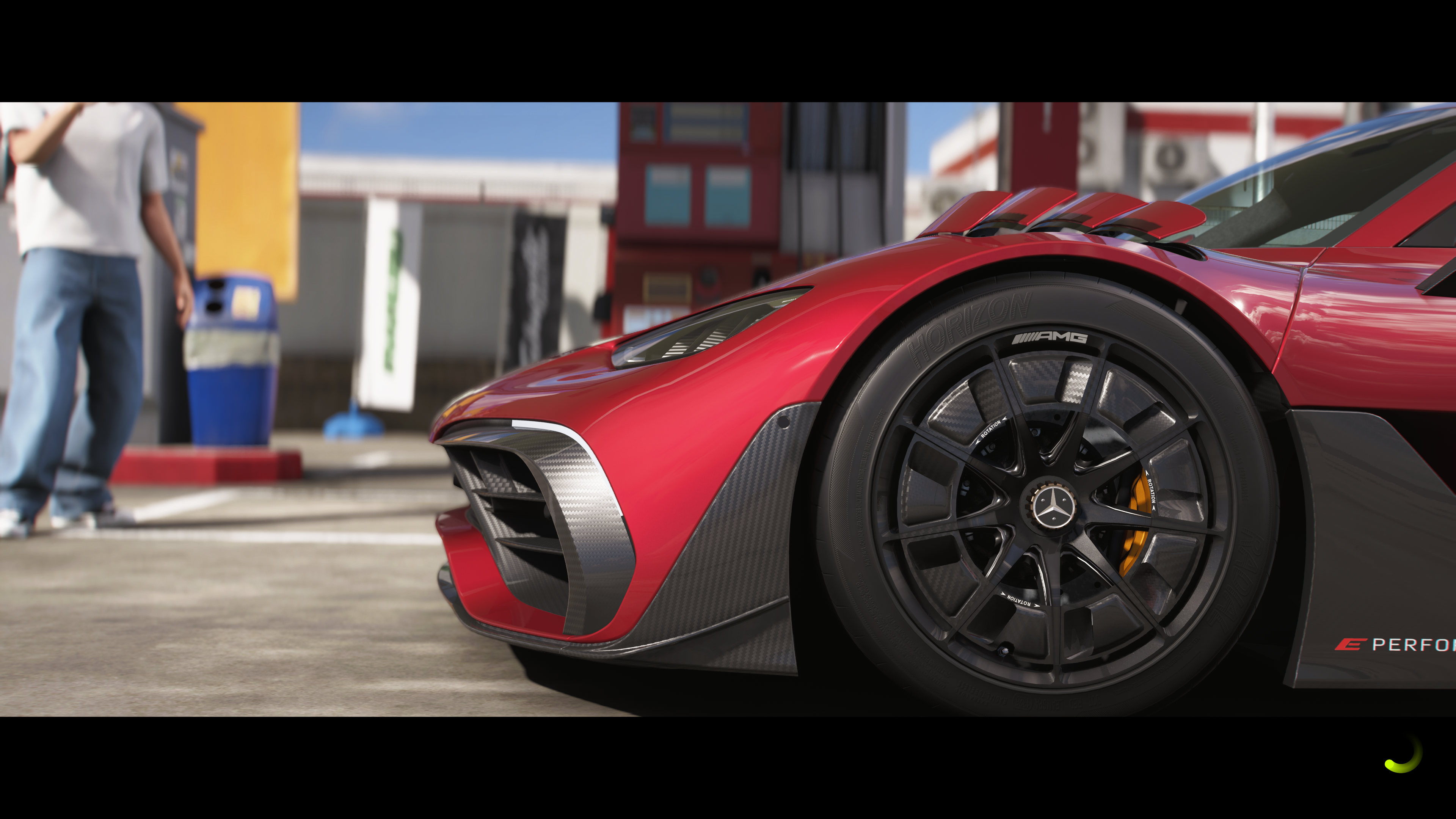 Super close up of the wheel of a Mercedes supercar, red paintwork, carbon detailing, and black rims