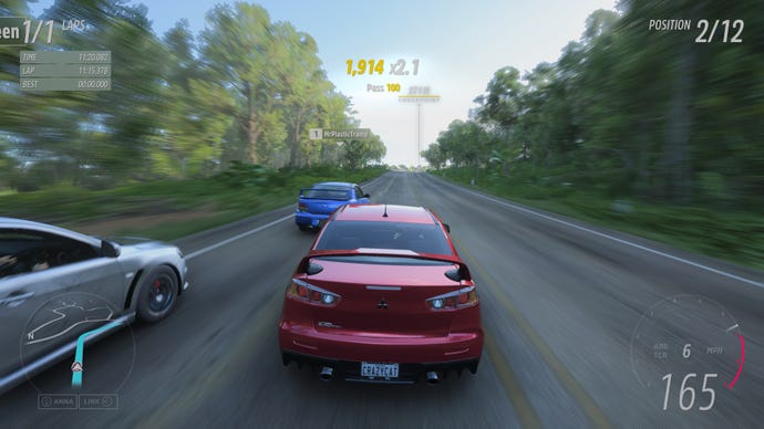 Cars race down a track in Forza Horizon 5
