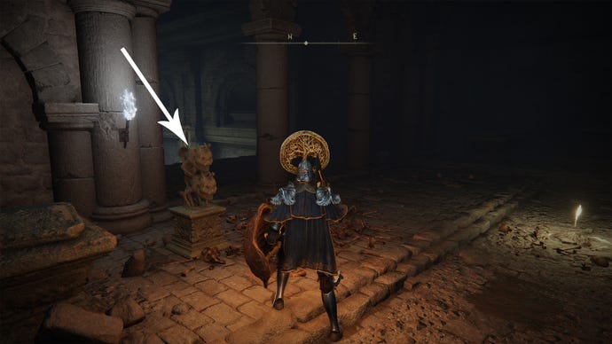 A stone statue in front of the Fringefolk Hero’s Grave in Elden Ring.