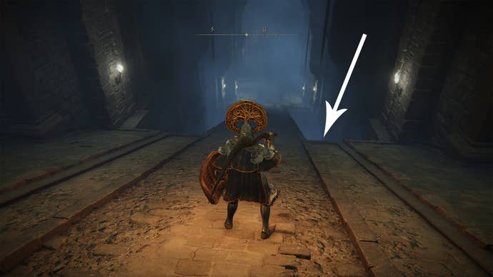 A narrow bridge inside the Fringefolk Hero’s Grave in Elden Ring.