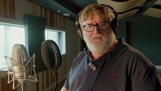 Gabe Newell in a recording studio, standing next to a microphone.