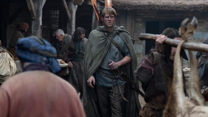 A still from A Knight of the Seven Kingdoms showing Ser Duncan the Tall walking through a crowded town.