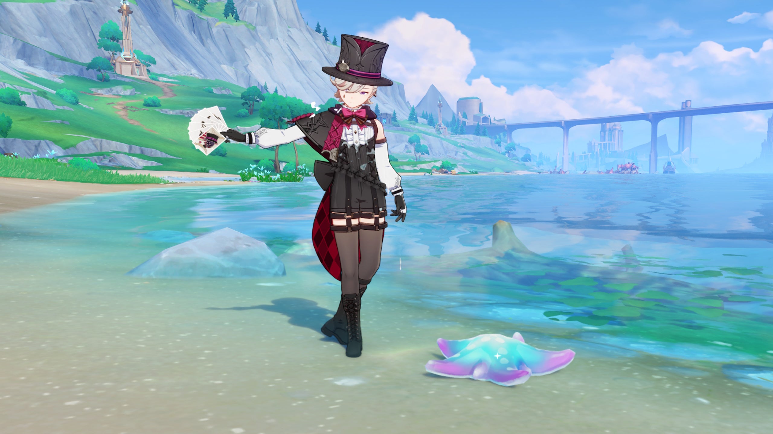 Genshin Impact Lumitoile locations: A young man in a black romper and top hat is standing near a Lumitoile - a blue and pink starfish - and flourishing a hand of cards