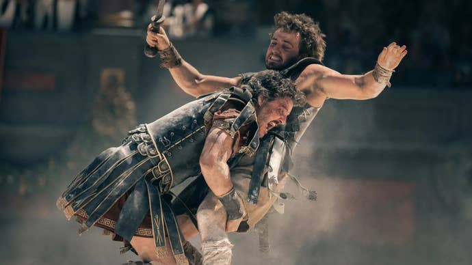 Two men, Pedro Pascal and Paul Mescal, in ancient Roman outfits, Pascal tackling him in Gladiator 2.